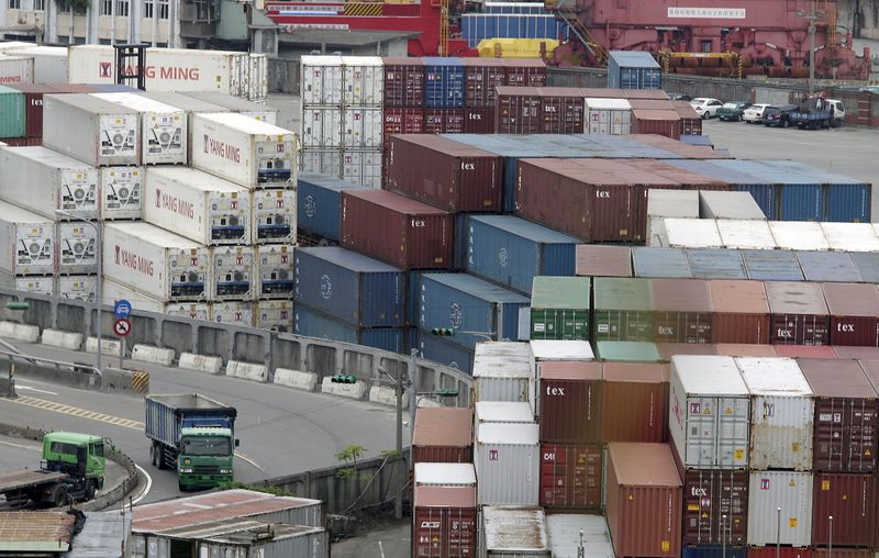 &copy; Reuters. FILE PHOTO: Trucks drive near containers at Keelung port, northern Taiwan, October 30, 2015. REUTERS/Pichi Chuang/File Photo