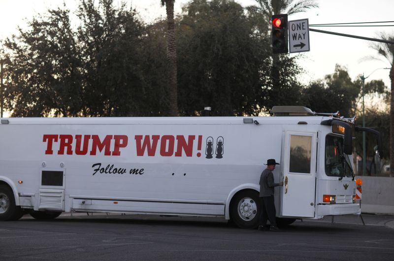 &copy; Reuters. FILE PHOTO: A supporter of U.S. President Donald Trump arrives by bus ahead of a protest against the election of President-elect Joe Biden, in Phoenix, Arizona, U.S. January 17, 2021. REUTERS/Caitlin O'Hara/File Photo
