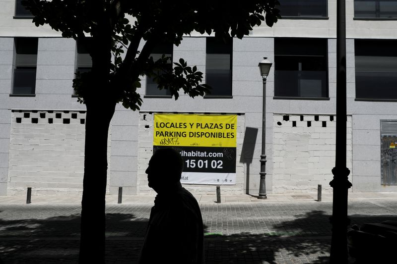 &copy; Reuters. FILE PHOTO: A man walks past a sign that reads "Properties and parking available" on the wall of an apartment complex in Madrid, Spain, June 19, 2019. REUTERS/Susana Vera