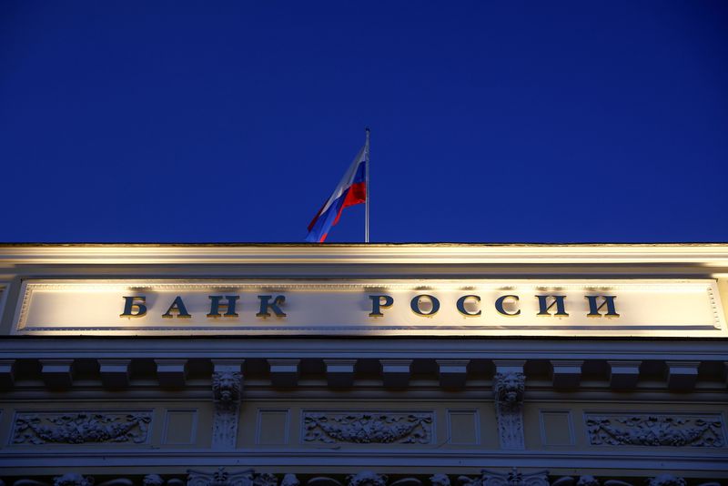 &copy; Reuters. FILE PHOTO: A Russian state flag flies over the Central Bank headquarters in Moscow, Russia March 29, 2021. A sign reads: "Bank of Russia". REUTERS/Maxim Shemetov/File Photo