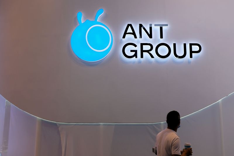 &copy; Reuters. FILE PHOTO: A man walks past an Ant Group logo at the World Artificial Intelligence Conference (WAIC) in Shanghai, China, July 8, 2021. REUTERS/Yilei Sun