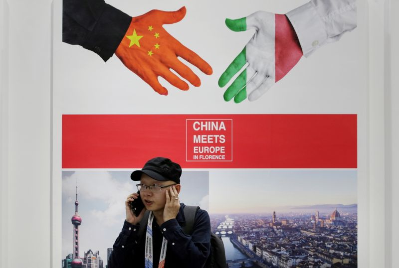 &copy; Reuters. FILE PHOTO: A man takes a call next to a poster stating "China meets Europe in Florence" at China International Fair for Trade in Services in Beijing, China, May 28, 2019. REUTERS/Jason Lee