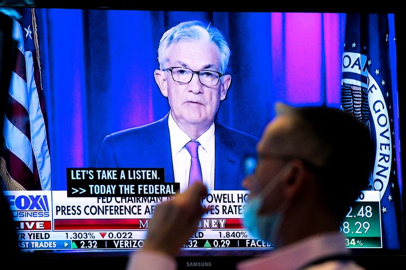 &copy; Reuters. A screen displays a statement by Federal Reserve Chair Jerome Powell following the U.S. Federal Reserve's announcement as a trader works on the trading floor of the New York Stock Exchange (NYSE) in New York City, U.S., September 22, 2021.  REUTERS/Brenda