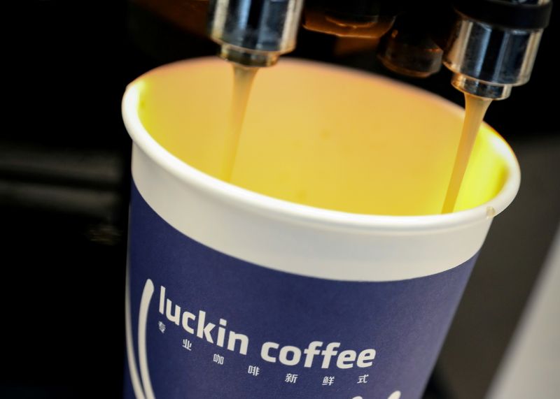 &copy; Reuters. FILE PHOTO: A cup of coffee is poured during Luckin Coffee's IPO at the Nasdaq Market site in New York, U.S., May 17, 2019. REUTERS/Brendan McDermid/File Photo