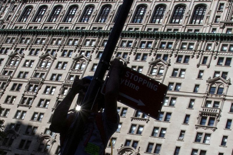 &copy; Reuters. FILE PHOTO: A man is silhouetted as he climbs a poll to signal to comrades during the 'Flood Wall Street' demonstration in Lower Manhattan, New York September 22, 2014.   REUTERS/Adrees Latif/File Photo