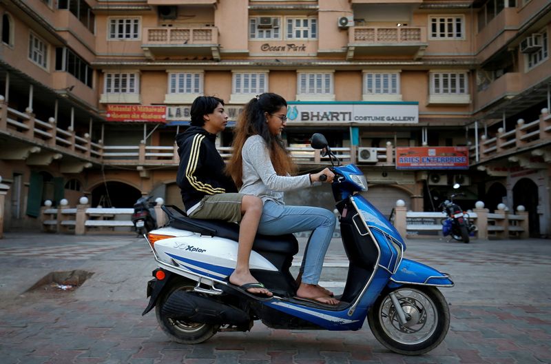 &copy; Reuters. FILE PHOTO: Girls ride an electric scooter in Ahmedabad, India, December 30, 2018. Picture taken December 30, 2018. REUTERS/Amit Dave/File Photo