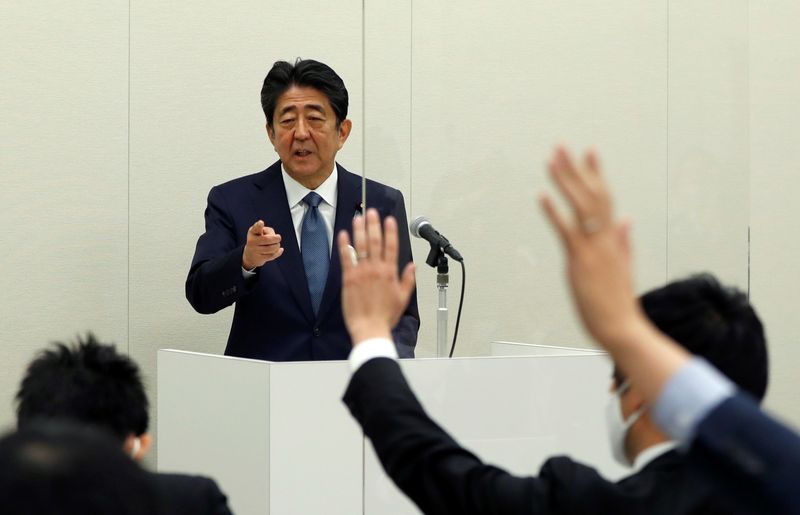 &copy; Reuters. FILE PHOTO: Former Japanese Prime Minister Shinzo Abe, embroiled in a case against his secretary over unreported political funds, holds a news conference in Tokyo, Japan December 24, 2020.  REUTERS/Issei Kato