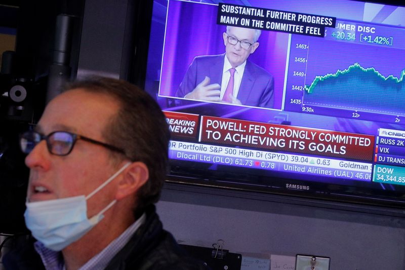 &copy; Reuters. FILE PHOTO: A screen displays a statement by Federal Reserve Chair Jerome Powell following the U.S. Federal Reserve's announcement as a trader works on the trading floor of the New York Stock Exchange (NYSE) in New York City, U.S., September 22, 2021.  RE