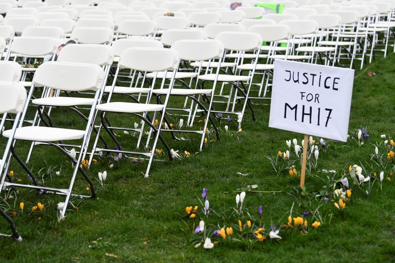 &copy; Reuters. FILE PHOTO: A protest sign stands next to rows of empty chairs, lined up by family members of victims of the MH17 crash line for each seat on the plane, during a protest outside the Russian Embassy in The Hague, Netherlands March 8, 2020.  REUTERS/Pirosch