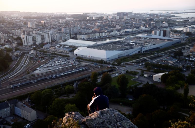 &copy; Reuters. A man seats on the heights of the shipbuilding town of Cherbourg-en-Contentin, France, September 22, 2021.  REUTERS/Stephane Mahe
