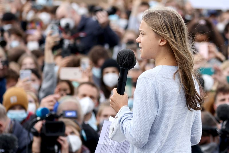 &copy; Reuters. スウェーデンの環境活動家グレタ・トゥンベリさん（写真）ら世界各地の若者らが２４日、気候変動への緊急対策を訴えてデモ活動を行った。（２０２１年　ロイター/Christian Mang）