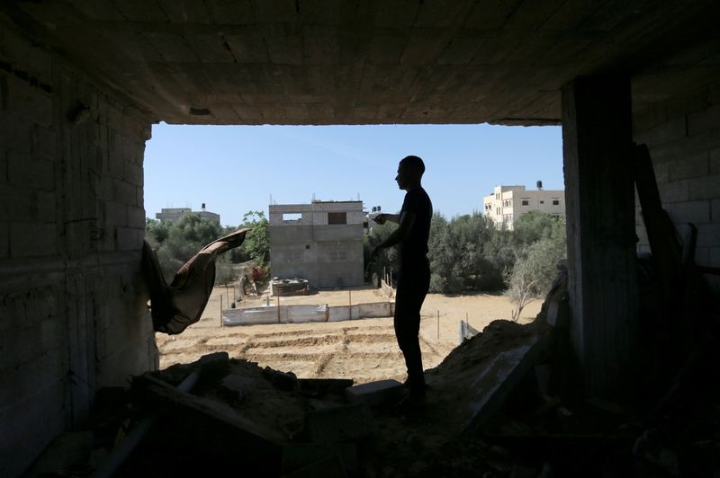 &copy; Reuters. A Palestinian man stands inside a house that was damaged by Israeli strikes during Israel-Hamas fighting last May, in Khan Younis in southern Gaza Strip September 26, 2021. REUTERS/Ibraheem Abu Mustafa     