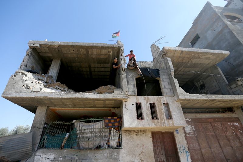 &copy; Reuters. عامل فلسطيني في منزل تعرض للدمار خلال حرب مايو ايار الماضي في خان يونس بقطاع غزة في صورة يوم الاحد. تصوير: إبراهيم أبو مصطفى - رويترز.