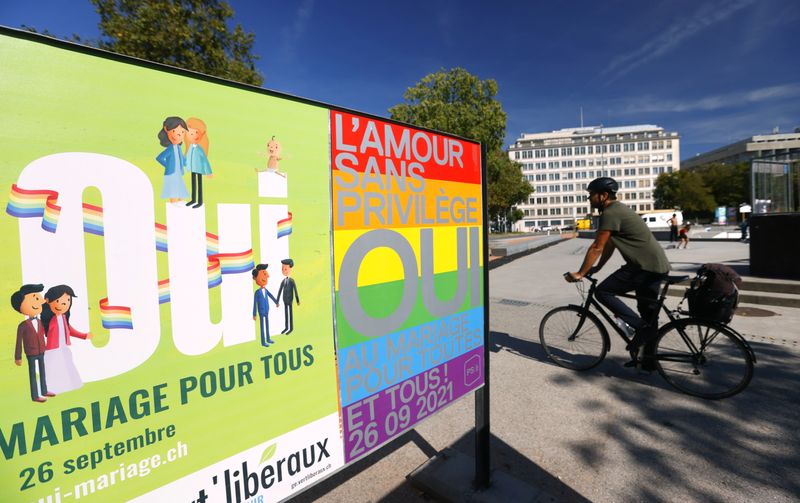 &copy; Reuters. FILE PHOTO: Posters are pictured before a vote on same sex marriage in Geneva, Switzerland, September 23, 2021. Poster reads : "Love without privilege, yes to marriage for all". REUTERS/Denis Balibouse