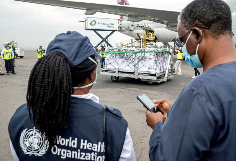 &copy; Reuters. FILE PHOTO: World Health Organization (WHO) officials attend the arrival of the first batch of vaccines against the coronavirus disease (COVID-19) at the Kigali international airport in Kigali, Rwanda March 3, 2021. REUTERS/Jean Bizimana