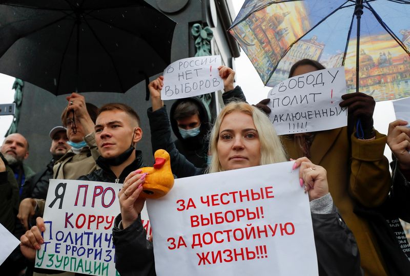 &copy; Reuters. Participants hold placards during an opposition rally to protest against the results of the Russian parliamentary election in Moscow, Russia September 25, 2021. Placards read: "Freedom to political prisoners" and "To fair elections! To decent life!" REUTE