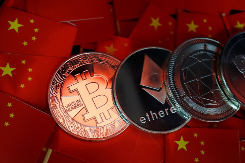 &copy; Reuters. Representations of Bitcoin and other cryptocurrencies are seen amid China's flags in this illustration picture taken September 27, 2021. REUTERS/Florence Lo/Illustration