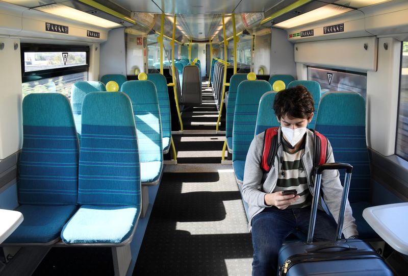 © Reuters. FILE PHOTO: A lone passenger wearing a face mask travels on an empty Southeastern train arriving at London Victoria, following the outbreak of the coronavirus disease (COVID-19), London, Britain, May 18, 2020. REUTERS/Toby Melville