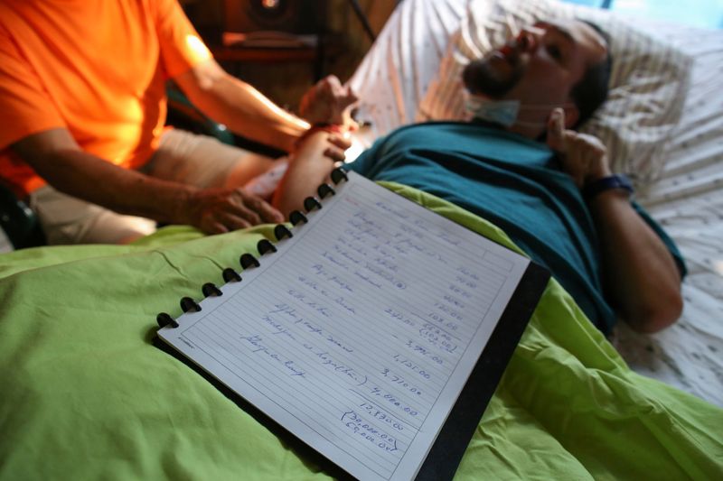 &copy; Reuters. A handwritten list made by Abraham Rivera Berrios shows the details of the expenses involved in caring for his son Emanuel Rivera, who was born severely disabled and needs constant care, at his home, in Toa Alta, Puerto Rico, September 22, 2021. Picture t