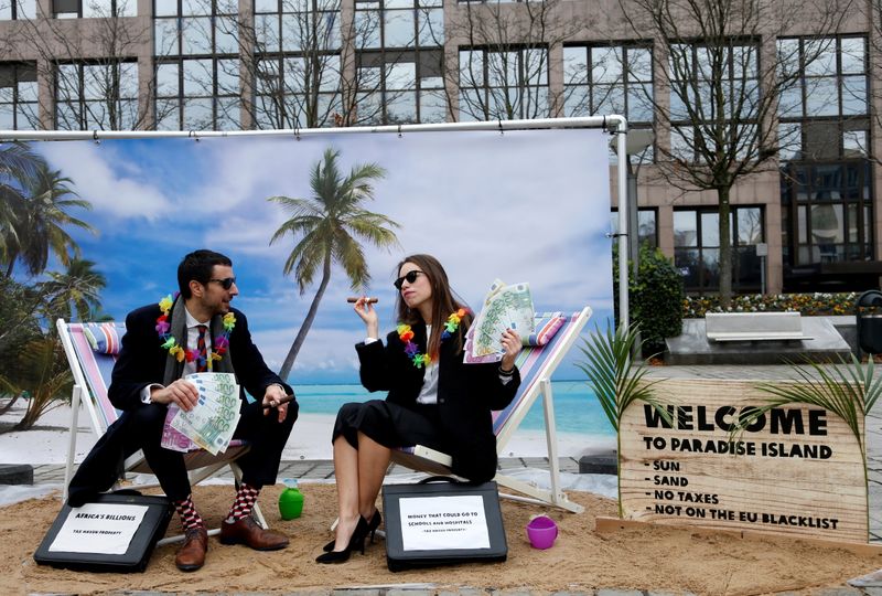 &copy; Reuters. FILE PHOTO: Activists stage a protest on a mock tropical island beach representing a tax haven outside a meeting of European Union finance ministers in Brussels, Belgium, December 5, 2017.  REUTERS/Francois Lenoir