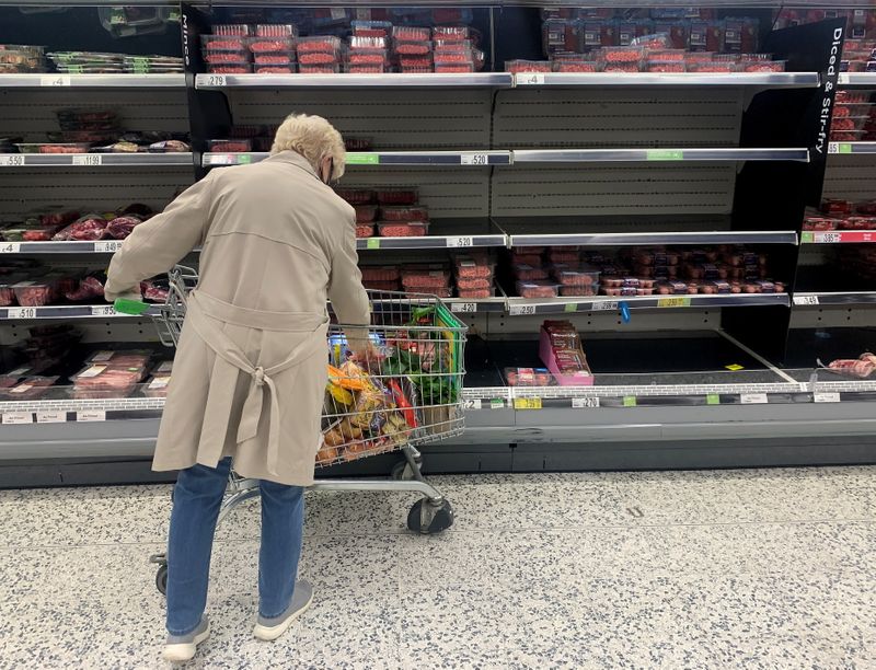 &copy; Reuters. FILE PHOTO: A shopper stands in front of empty shelves in the meat aisle of a supermarket in Liverpool, Britain, September 20, 2021. REUTERS/Phil Noble