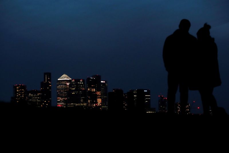 &copy; Reuters. FILE PHOTO: People look out to Canary Wharf business district at dusk, in London, Britain March 9, 2021. REUTERS/Peter Cziborra