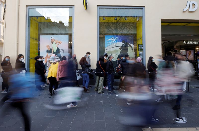 &copy; Reuters. FILE PHOTO: People, wearing protective face masks, queue outside a shop in a street in Nice as France' 16 hardest-hit departments will go into a third lockdown imposed to slow the rate of the coronavirus disease (COVID-19) contagion, March 19, 2021.  REUT