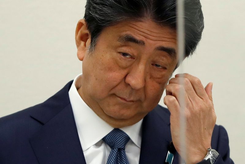 &copy; Reuters. FILE PHOTO: Former Japanese Prime Minister Shinzo Abe, embroiled in a case against his secretary over unreported political funds, gestures as he attends a news conference in Tokyo, Japan December 24, 2020.  REUTERS/Issei Kato