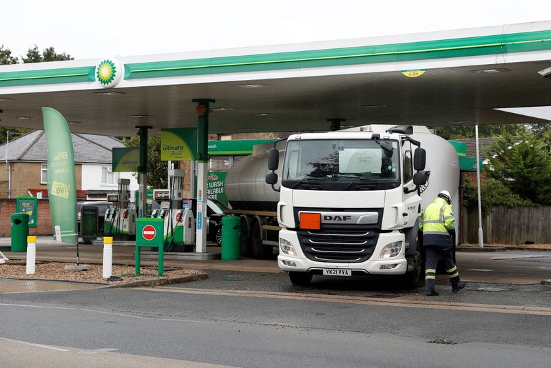 © Reuters. A driver walks past his tanker after completing a fuel delivery to a BP filling station in Hersham, Britain, September 30, 2021. REUTERS/Peter Nicholls