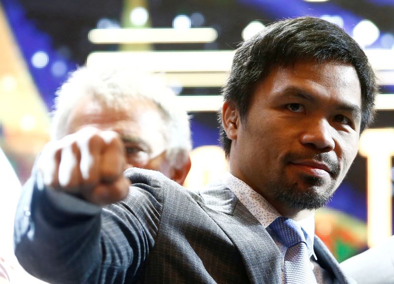 &copy; Reuters. FILE PHOTO: Philippine boxing icon Manny "Pacman" Pacquiao poses for photographers during a news conference with welterweight world title holder Lucas Matthysse (not pictured), for their upcoming WBA "regular" welterweight title fight, at a hotel in Kuala