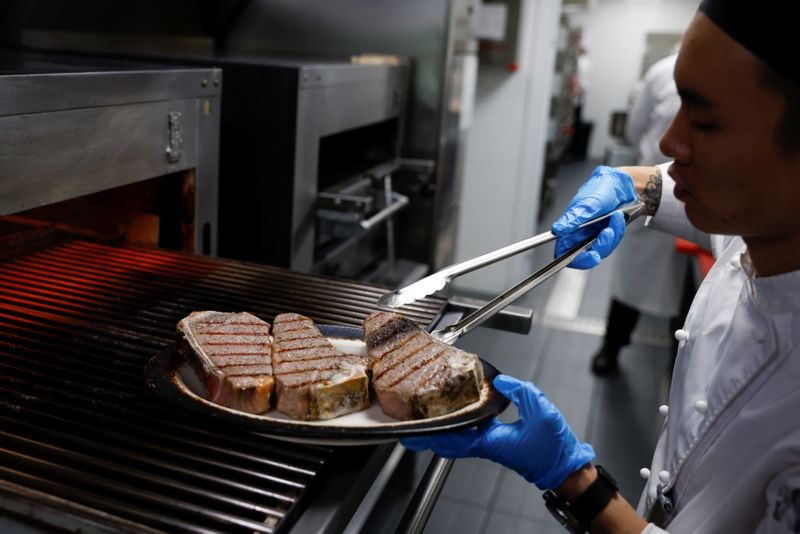&copy; Reuters. A chef cooks beef steaks at the kitchen of Wolfgang's Steakhouse restaurant which specialises in high quality U.S. beef, in Beijing, China September 8, 2021. Picture taken September 8, 2021. REUTERS/Carlos Garcia Rawlins