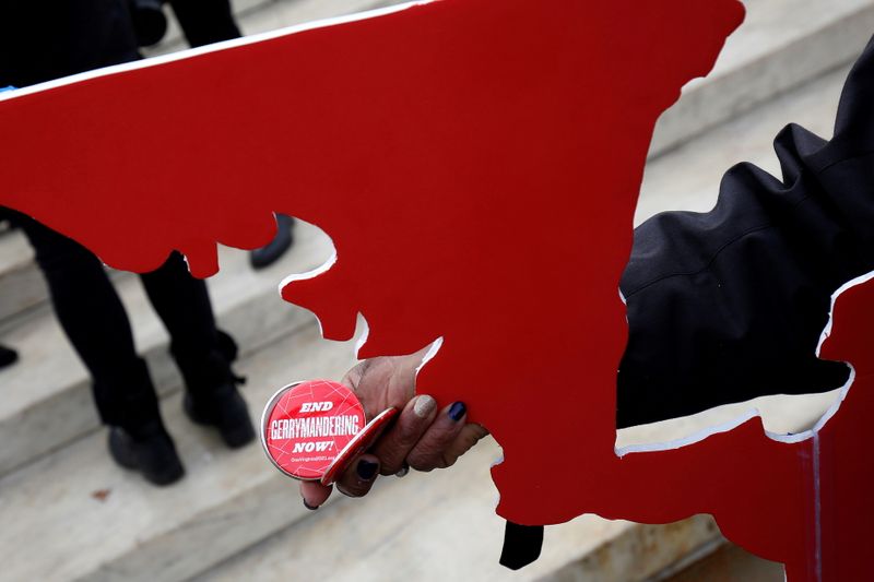 &copy; Reuters. FILE PHOTO: Demonstrators hold buttons in front of the Supreme court before oral arguments on Benisek v. Lamone, a redistricting case on whether Democratic lawmakers in Maryland unlawfully drew a congressional district in a way that would prevent a Republ