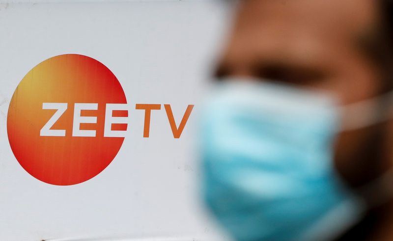 &copy; Reuters. FILE PHOTO: A guard stands next to a banner of Zee television outside a film studio in Mumbai, India, September 24, 2021. REUTERS/Francis Mascarenhas