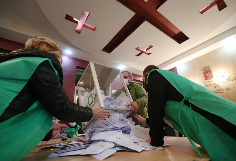 &copy; Reuters. Members of a local election commission empty a ballot box before counting votes during the municipal elections in Tbilisi, Georgia October 2, 2021. REUTERS/Irakli Gedenidze
