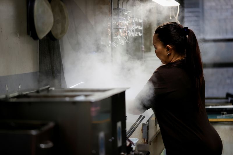 &copy; Reuters. A Jewelry worker works at a steam cleaning machine in a workshop at RFG Manufacturing Riviera jewelry design facility in Manhattan in New York City, New York, U.S., September 30, 2021. Picture taken September 30, 2021.  REUTERS Mike Segar