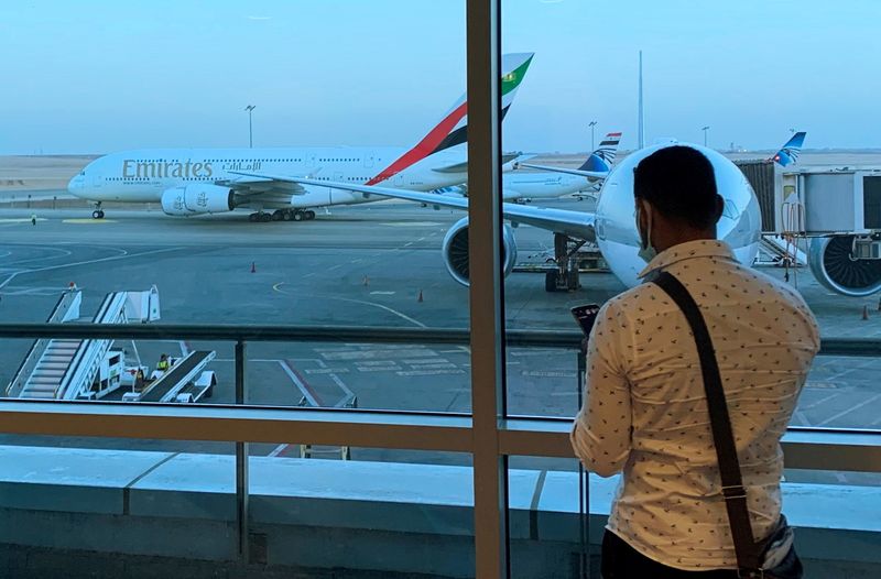 &copy; Reuters. FILE PHOTO: A passenger waits for his Emirates Airlines' flight departure to Dubai at Cairo's International Airport, Egypt July 20, 2021. REUTERS/Amr Abdallah Dalsh 