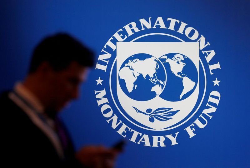 &copy; Reuters. FILE PHOTO: A participant stands near a logo of IMF at the International Monetary Fund - World Bank Annual Meeting 2018 in Nusa Dua, Bali, Indonesia, October 12, 2018. REUTERS/Johannes P. Christo/File Photo