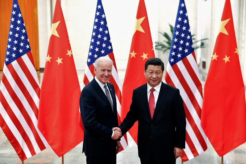 © Reuters. FILE PHOTO: Chinese President Xi Jinping shakes hands with then-U.S. Vice President Joe Biden (L) inside the Great Hall of the People in Beijing December 4, 2013. REUTERS/Lintao Zhang/Pool/File Photo