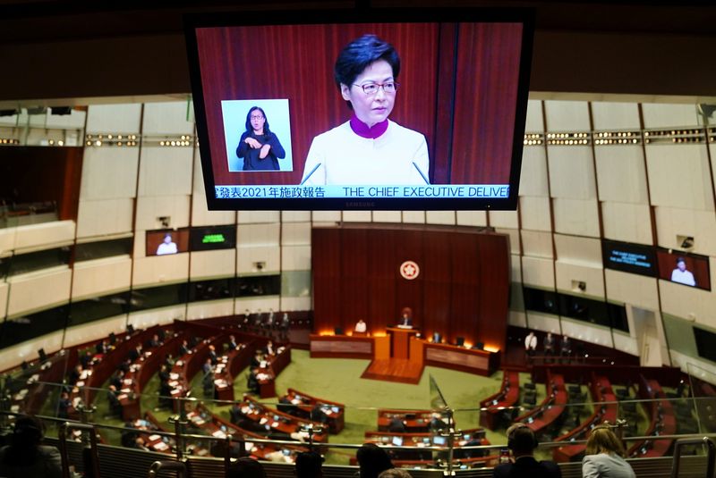 &copy; Reuters. Hong Kong Chief Executive Carrie Lam is seen on a tv screen as she delivers her annual policy address at the Legislative Council in Hong Kong, China October 6, 2021. REUTERS/Lam Yik