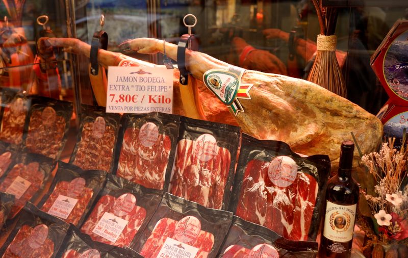 &copy; Reuters. FILE PHOTO: Hams and slices of ham are seen in a bar in Madrid, Spain, October 3, 2019. REUTERS/Jon Nazca