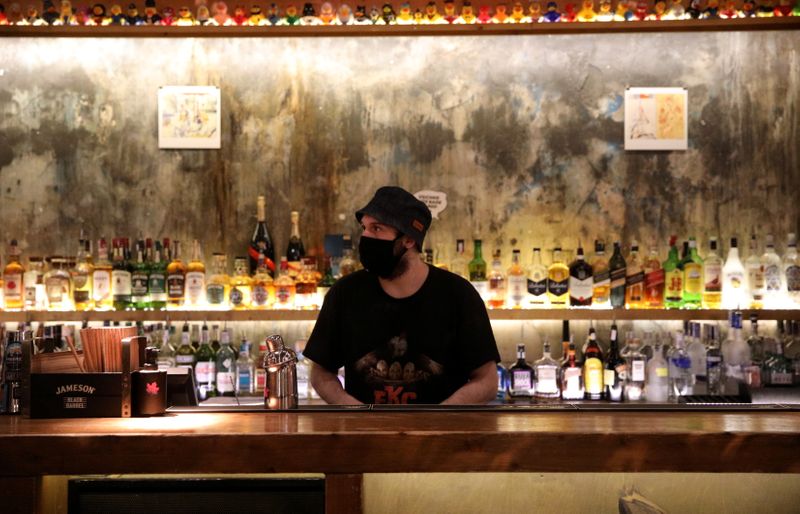 © Reuters. FILE PHOTO: A bartender wearing a protective face mask is pictured at Bar Friday, as night clubs reopen at 50 percent capacity, following the outbreak of the coronavirus disease (COVID-19), in Sofia, Bulgaria, April 29, 2021.  REUTERS/Spasiyana Sergieva