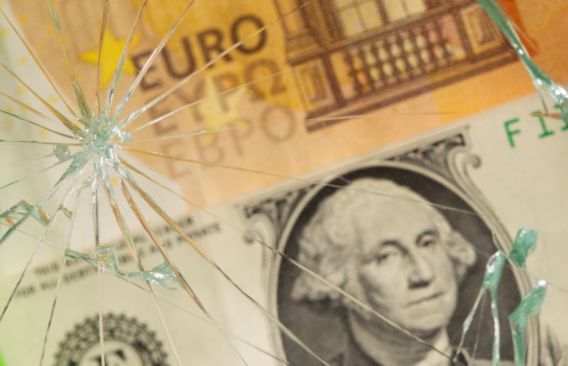 &copy; Reuters. U.S. dollar and euro banknotes are seen through broken glass in this illustration taken, June 25, 2021. REUTERS/Dado Ruvic/Illustration