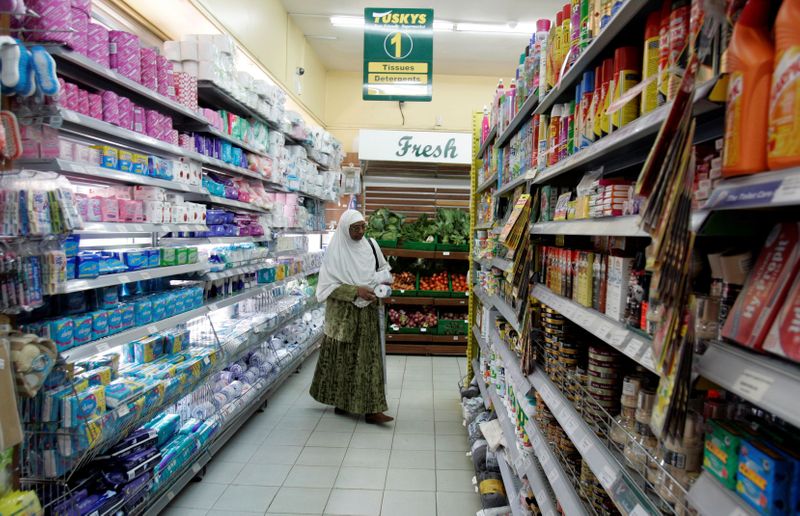 &copy; Reuters. FILE PHOTO: A woman shops at a supermarket in Nairobi October 23, 2008.  Economic growth in sub-Saharan Africa will dip to 6 percent in 2008 and 2009 due to tough global conditions, while inflation is seen rising to 12 percent this year, the International