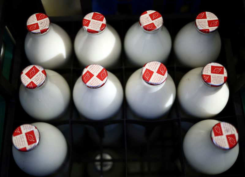 © Reuters. FILE PHOTO: Bottles of milk are seen on a milk float during the morning delivery round in the town of Sawbridgeworth, as business for the 'Mr Milk' milkman company booms, as the spread of the coronavirus disease (COVID-19) continues in Hertfordshire, Britain, April 22, 2020. REUTERS/Hannah McKay
