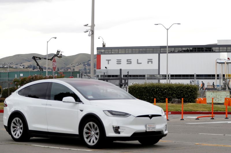 &copy; Reuters. FILE PHOTO: A Tesla vehicle drives past Tesla's primary vehicle factory after CEO Elon Musk announced he was defying local officials' coronavirus disease (COVID-19) restrictions by reopening the plant in Fremont, California, U.S. May 11, 2020. REUTERS/Ste
