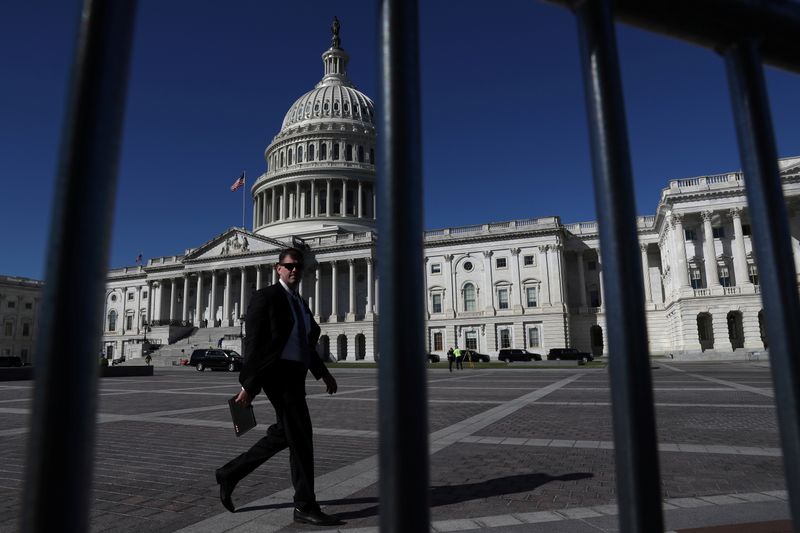 &copy; Reuters. FILE PHOTO: A man walks past the U.S. Capitol building in Washington, U.S., September 30, 2021. REUTERS/Leah Millis/Files