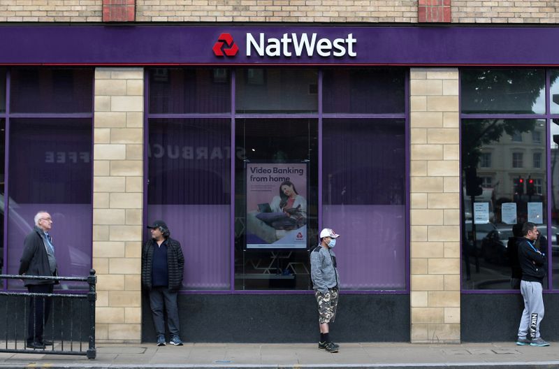 &copy; Reuters. FILE PHOTO: People maintain social distance while they queue outside a Natwest bank in Wimbledon in London, Britain, May 1, 2020. REUTERS/Hannah McKay/File Photo