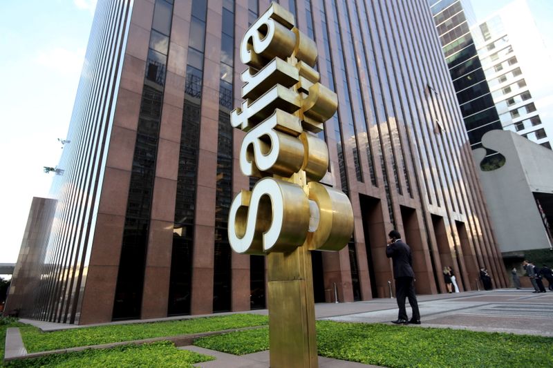 &copy; Reuters. FILE PHOTO: A man walks in front of the  Banco Safra SA headquarter in Sao Paulo March 26, 2015. REUTERS/Paulo Whitaker/File Photo