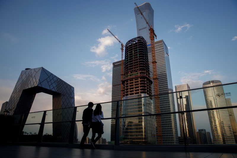&copy; Reuters. FILE PHOTO: People look at the skyline of the Central Business District in Beijing, China,  April 16, 2020.  REUTERS/Thomas Peter