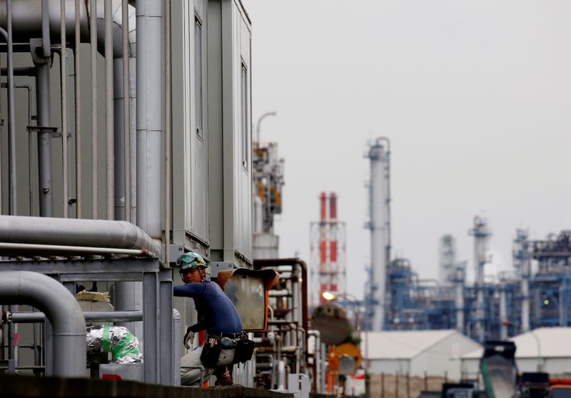 &copy; Reuters. FILE PHOTO: A worker is seen in front of facilities and chimneys of factories at the Keihin Industrial Zone in Kawasaki, Japan September 12, 2018. REUTERS/Kim Kyung-Hoon